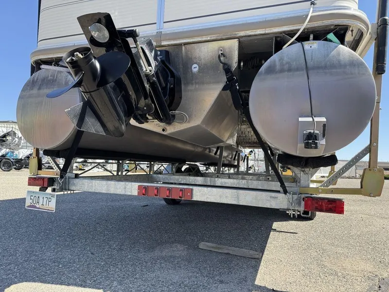 Slide: The Image of 2006 Sun Tracker Party Cruiser 32 pontoon boat on trailer, rear view showing motor and pontoons. - 11