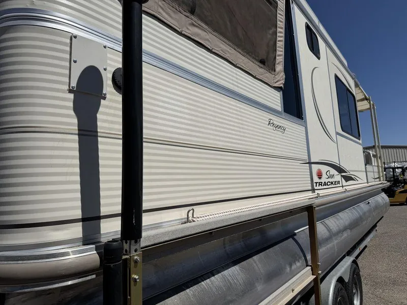 Slide: The Image of 2006 Sun Tracker Party Cruiser 32 pontoon boat, side view, parked outdoors. - 13