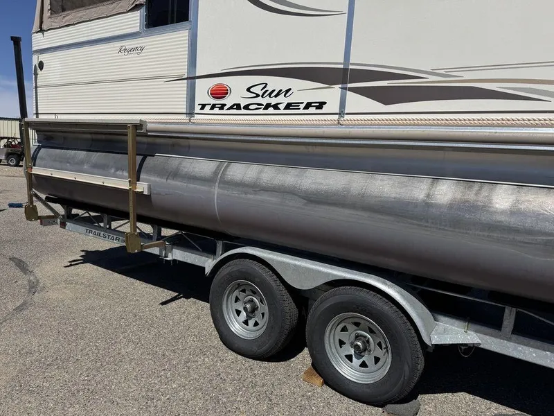 Slide: The Image of 2006 Sun Tracker Party Cruiser 32 on trailer, side view, showing pontoons and branding. - 14