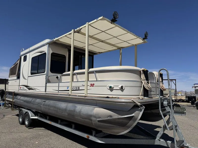 Slide: The Image of 2006 Sun Tracker Party Cruiser 32 pontoon boat on trailer under clear blue sky. - 17