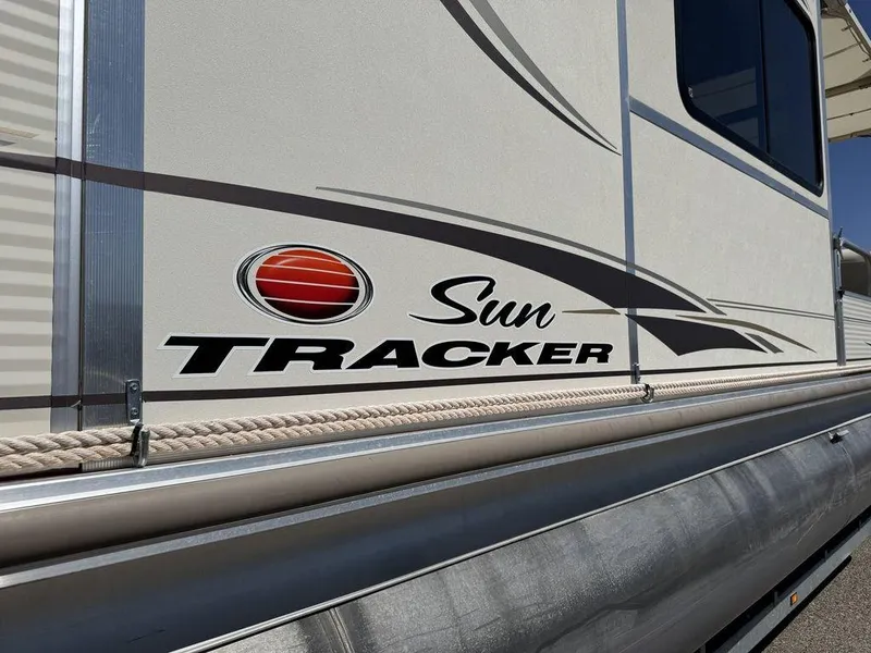 Slide: The Image of 2006 Sun Tracker Party Cruiser 32 boat side view with logo and design details. - 20
