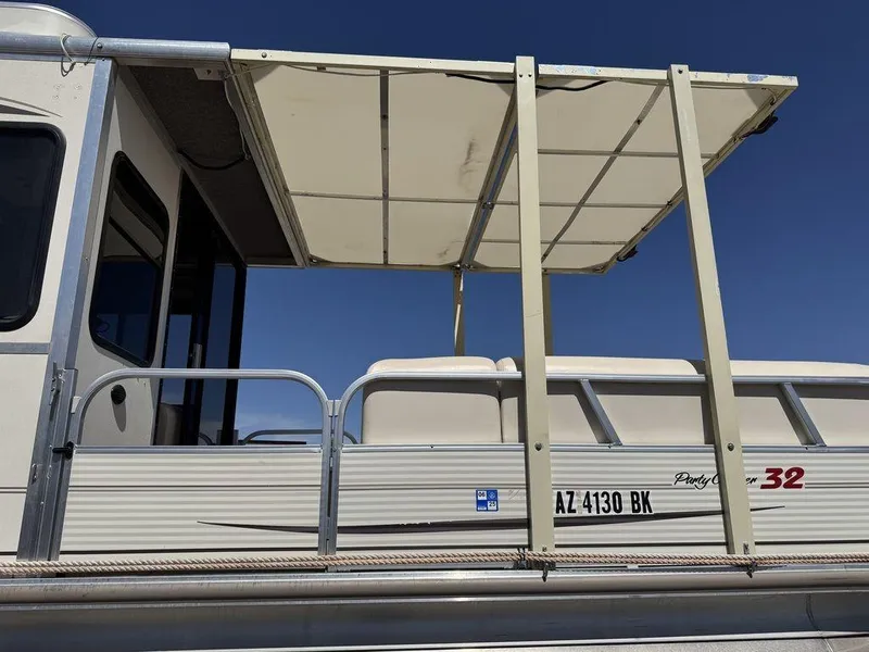Slide: The Image of 2006 Sun Tracker Party Cruiser 32 with canopy and seating, side view. - 23