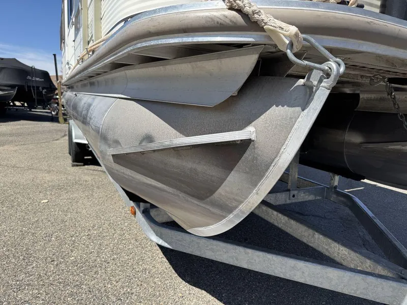Slide: The Image of 2006 Sun Tracker Party Cruiser 32 pontoon boat on trailer, close-up view. - 24