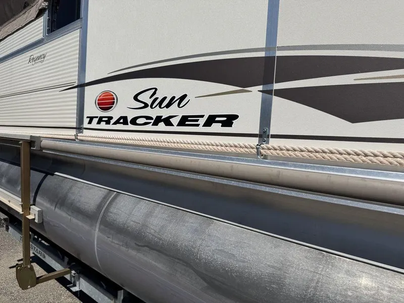 Slide: The Image of 2006 Sun Tracker Party Cruiser 32 pontoon boat side view with logo and design details. - 31