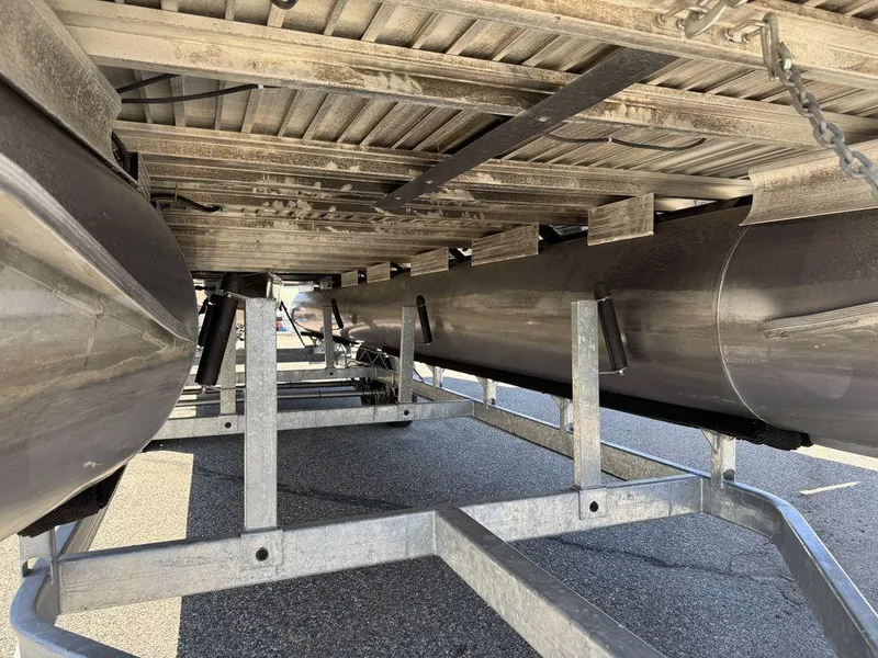 Slide: The Image of Underneath view of a 2006 Sun Tracker Party Cruiser 32 pontoon boat on a trailer. - 32