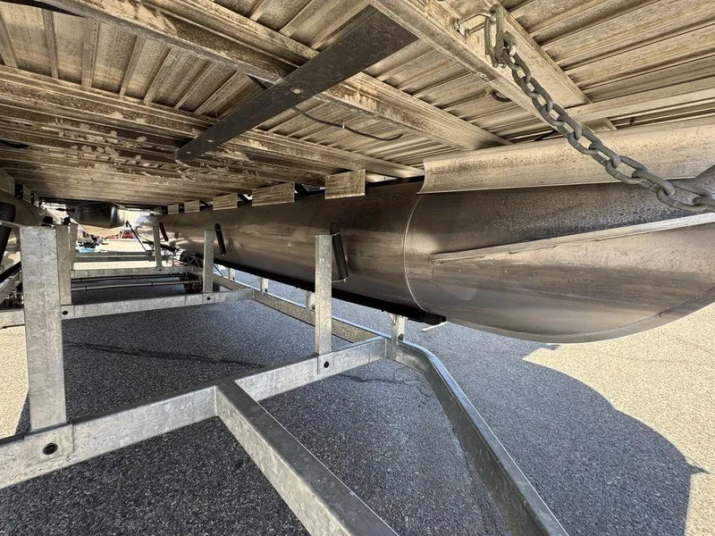 Slide: The Image of Underneath view of a 2006 Sun Tracker Party Cruiser 32 pontoon boat on a trailer. - 34