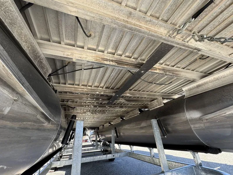 Slide: The Image of Underneath view of a 2006 Sun Tracker Party Cruiser 32 pontoon boat on a trailer. - 36