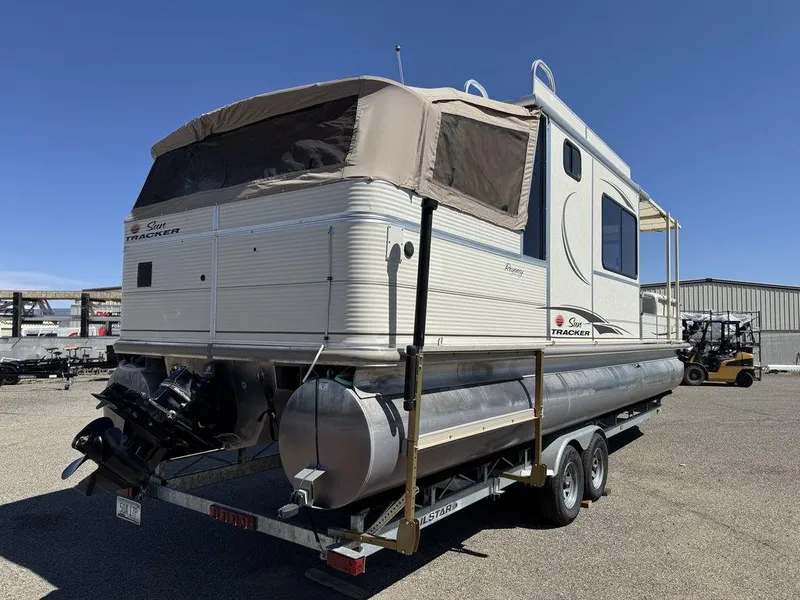 Slide: The Image of 2006 Sun Tracker Party Cruiser 32 pontoon boat on trailer, parked outdoors. - 4