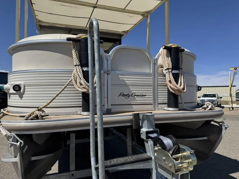 Slide: The Image of 2006 Sun Tracker Party Cruiser 32 pontoon boat on trailer, featuring ropes and winch. - 40