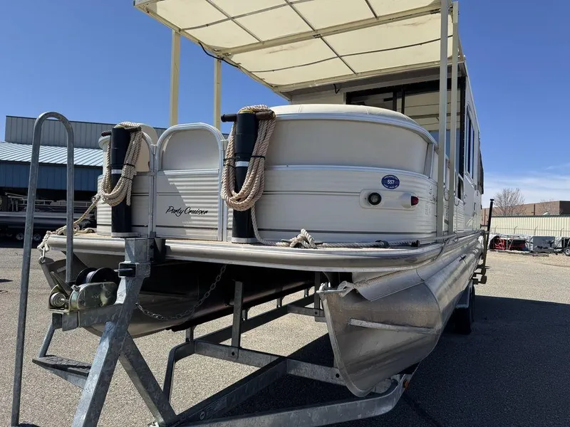 Slide: The Image of 2006 Sun Tracker Party Cruiser 32 pontoon boat on trailer, featuring a covered deck. - 41