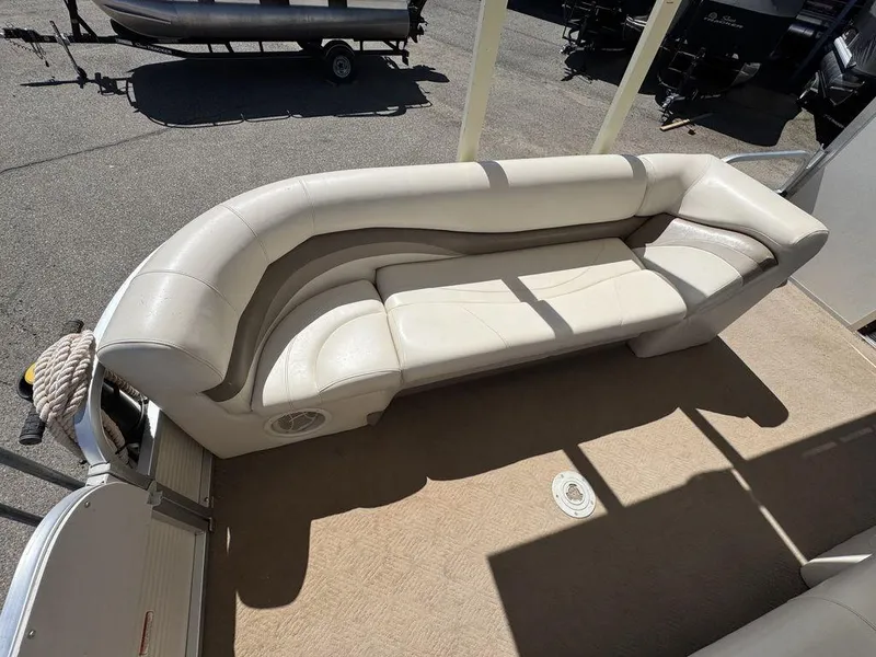 Slide: The Image of 2006 Sun Tracker Party Cruiser 32 interior with beige seating and carpeted floor. - 45