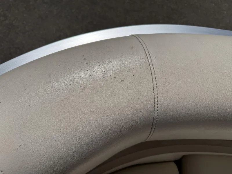 Slide: The Image of Close-up of beige upholstery on a 2006 Sun Tracker Party Cruiser 32 boat. - 49