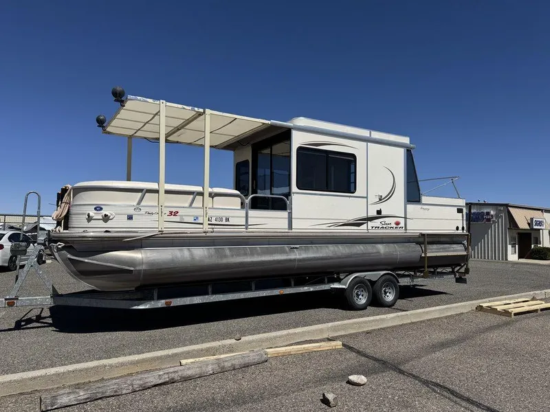 Slide: The Image of 2006 Sun Tracker Party Cruiser 32 pontoon boat on trailer, parked outdoors. - 6