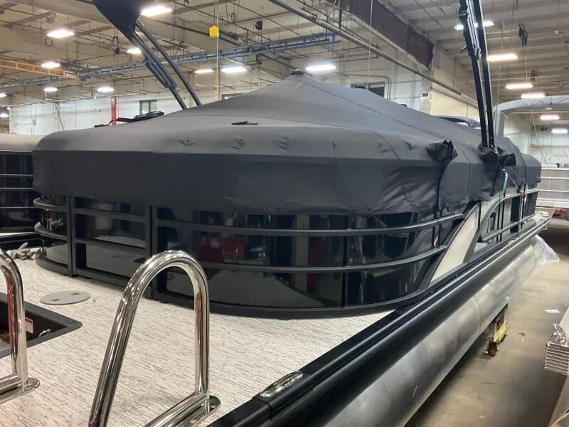 Slide: The Image of 2025 Bennington 22 LSRSE pontoon boat in a factory setting, showcasing sleek design. - 11