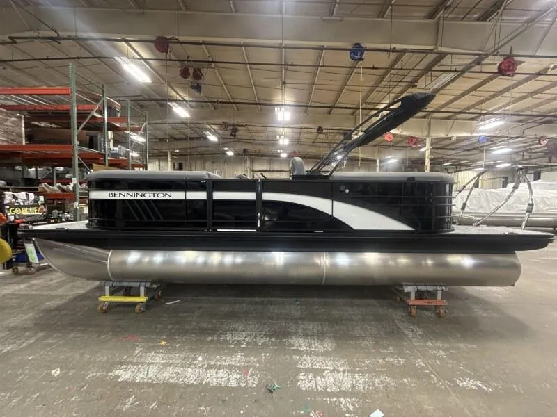 Slide: The Image of 2025 Bennington 22 LSRSE pontoon boat in a factory setting, front view. - 2
