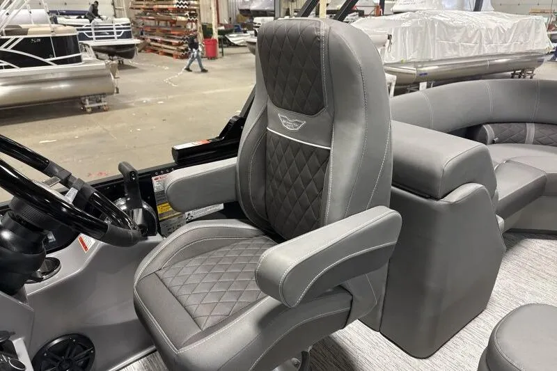Slide: The Image of 2025 Bennington 22 LSRSE boat interior with luxurious gray captain's chair and steering wheel. - 20
