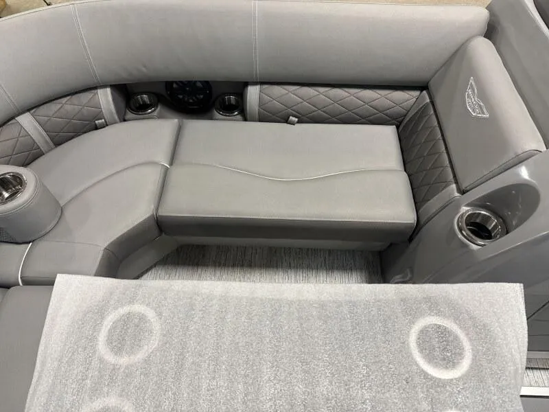 Slide: The Image of 2025 Bennington 22 LSRSE pontoon boat with cover in a warehouse setting. - 8