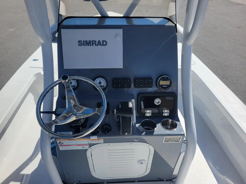 Slide: The Image of 2025 Blazer Bay 2420 GTS Deluxe boat console with steering wheel and Simrad electronics. - 16