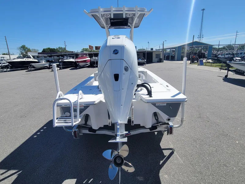 Slide: The Image of 2025 Blazer Bay 2420 GTS Deluxe boat, rear view, in a marina setting. - 3