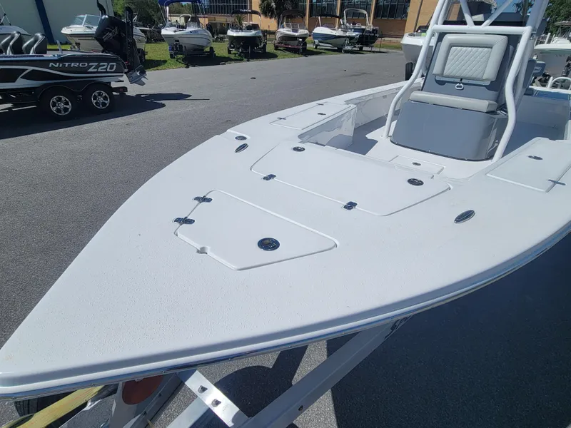 Slide: The Image of 2025 Blazer Bay 2420 GTS Deluxe boat on display in a sunny outdoor setting. - 7