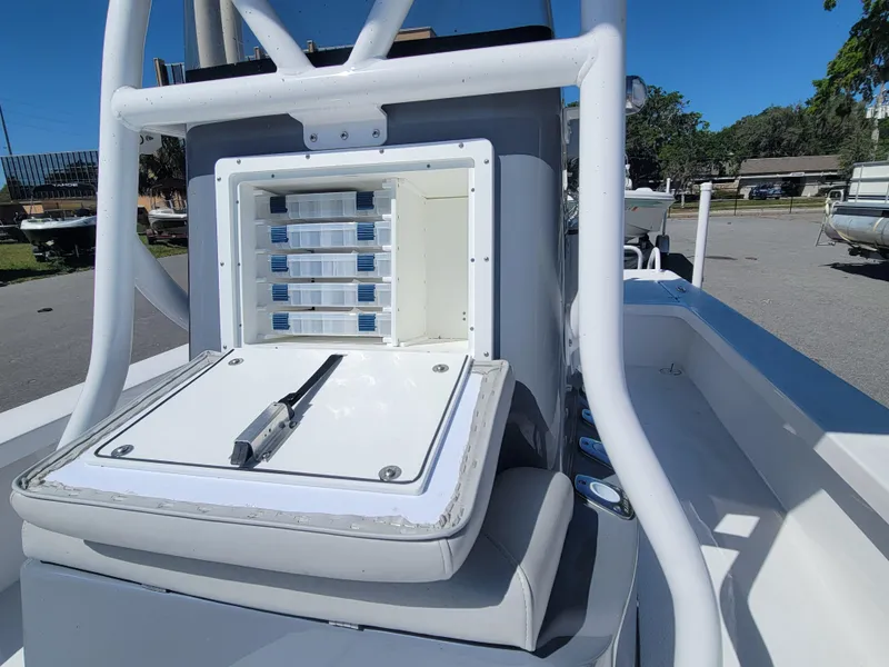 Slide: The Image of 2025 Blazer Bay 2420 GTS Deluxe boat with open storage compartment and tackle boxes. - 9
