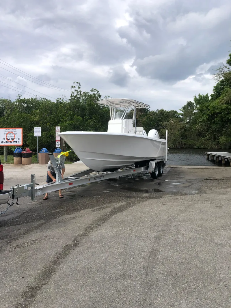 Slide: The Image of 2021 Contender Tournament boat on trailer at a boat ramp under cloudy skies. - 2