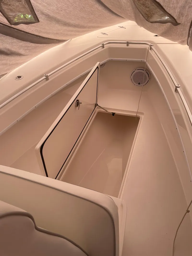 Slide: The Image of 2021 Contender Tournament boat interior with open storage compartment under tarp. - 6