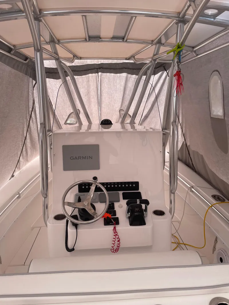 Slide: The Image of 2021 Contender Tournament boat interior with Garmin navigation system and steering wheel. - 8