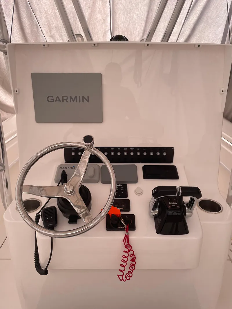 Slide: The Image of 2021 Contender Tournament boat console with Garmin navigation system and steering wheel. - 9