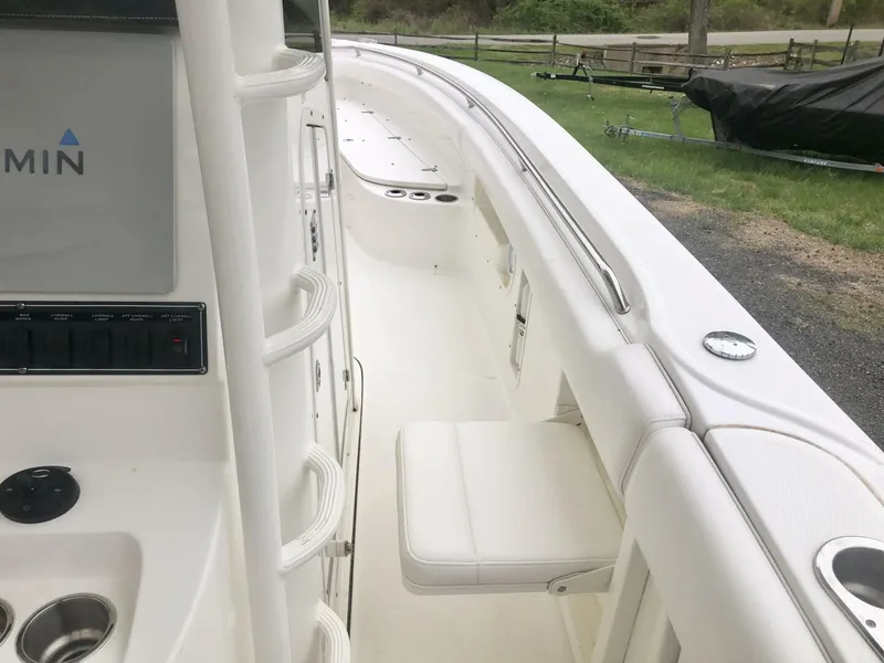 Slide: The Image of 2016 Boston Whaler OUTRAGE boat interior with seating and control panel. - 16