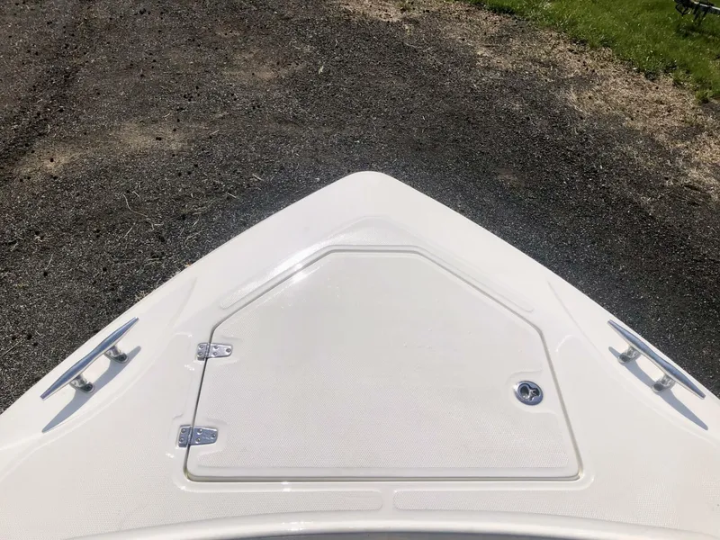 Slide: The Image of Bow of 2016 Boston Whaler OUTRAGE boat with storage hatch and cleats. - 21