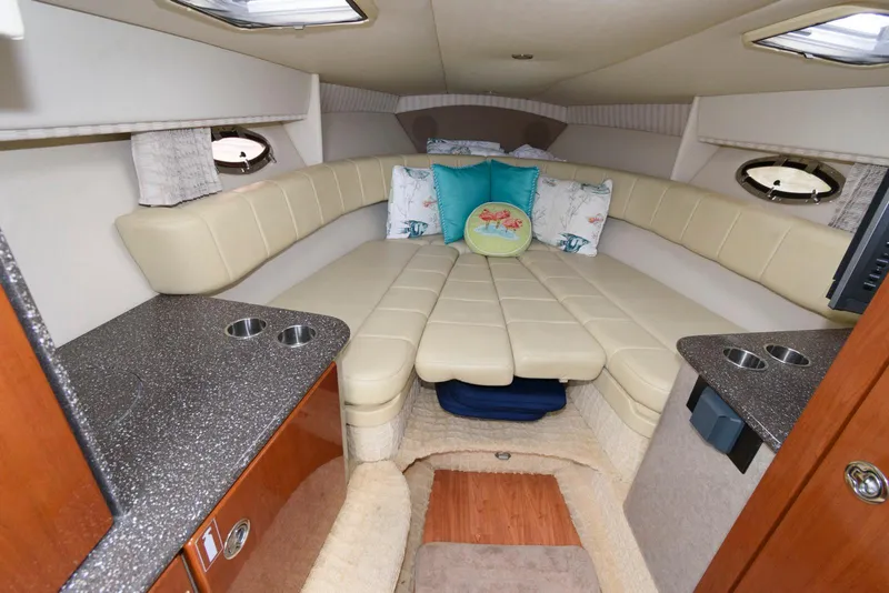 Slide: The Image of 2007 Formula 330 Sun Sport cabin interior with beige seating and decorative pillows. - 10