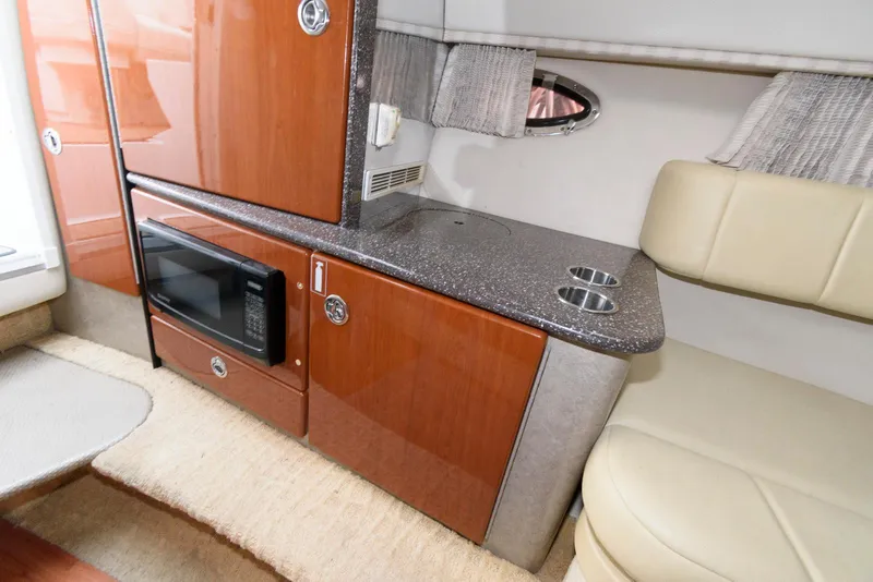 Slide: The Image of Interior of 2007 Formula 330 Sun Sport boat with kitchenette and seating area. - 11