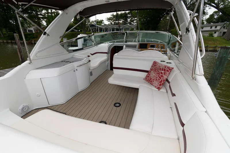 Slide: The Image of 2007 Formula 330 Sun Sport boat interior with white seating and red pillow. - 2