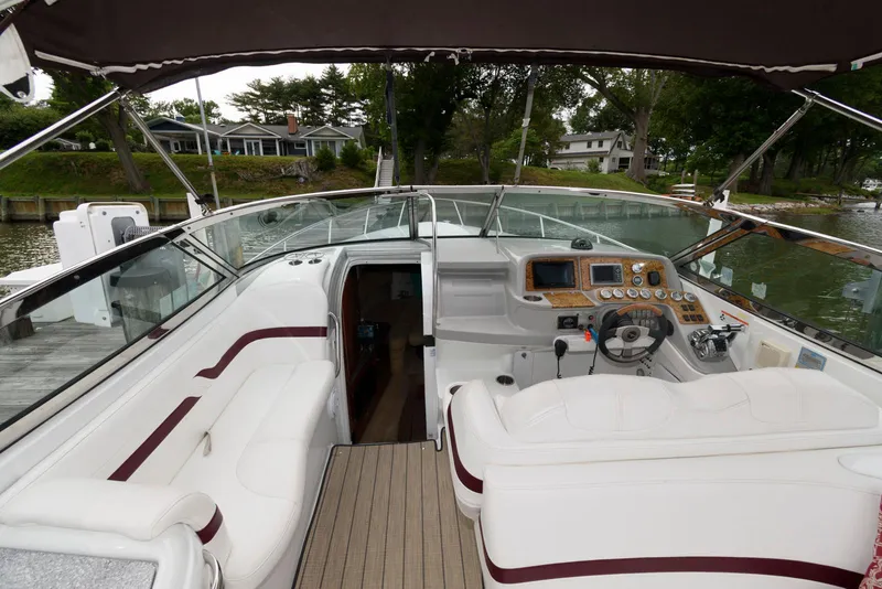 Slide: The Image of 2007 Formula 330 Sun Sport boat interior with white seating and control panel. - 4
