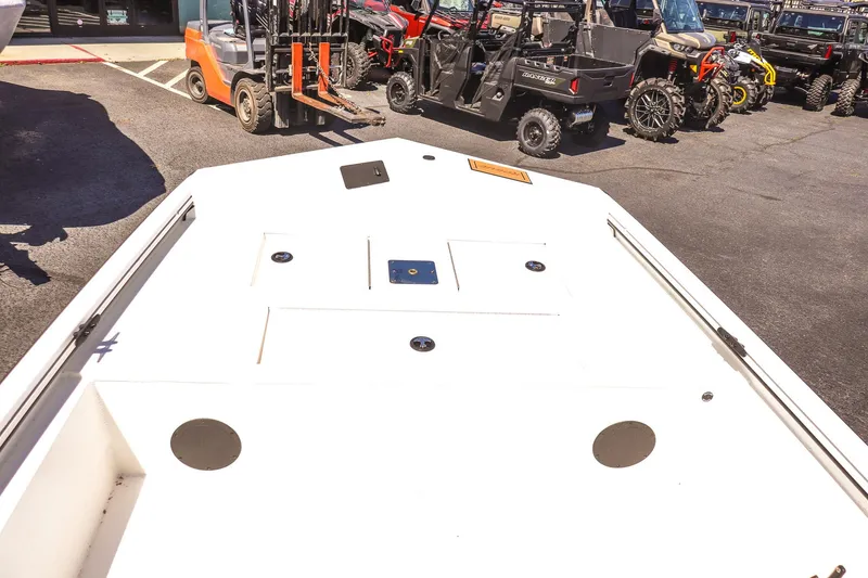 Slide: The Image of Avid 20 ROGUE CC 2025 boat deck, parked near off-road vehicles. - 12