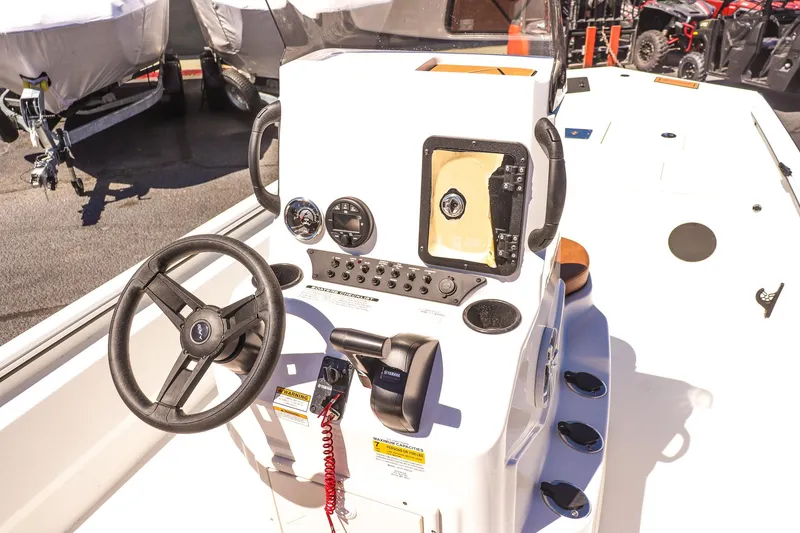 Slide: The Image of 2025 Avid 20 ROGUE CC boat console with steering wheel and controls. - 20