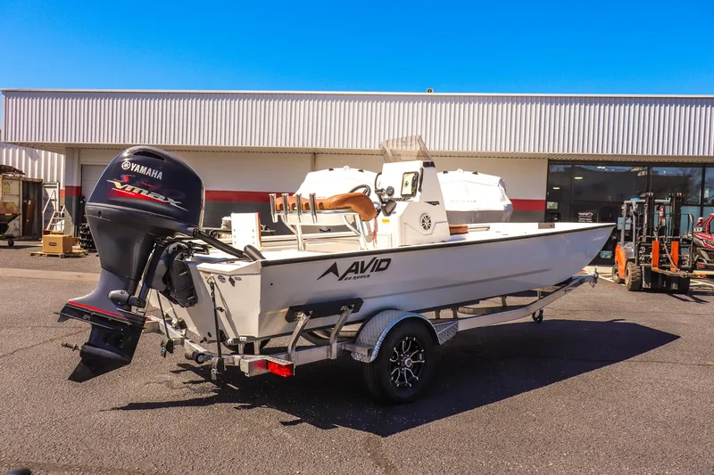 Slide: The Image of Avid 20 ROGUE CC 2025 boat on trailer with Yamaha outboard motor, parked outdoors. - 3