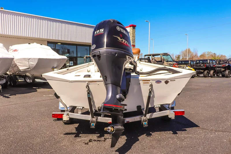Slide: The Image of Avid 20 ROGUE CC 2025 boat with Yamaha engine on trailer in dealership lot. - 4