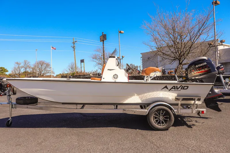 Slide: The Image of 2025 Avid 20 ROGUE CC boat on trailer with Yamaha engine, parked outdoors. - 6