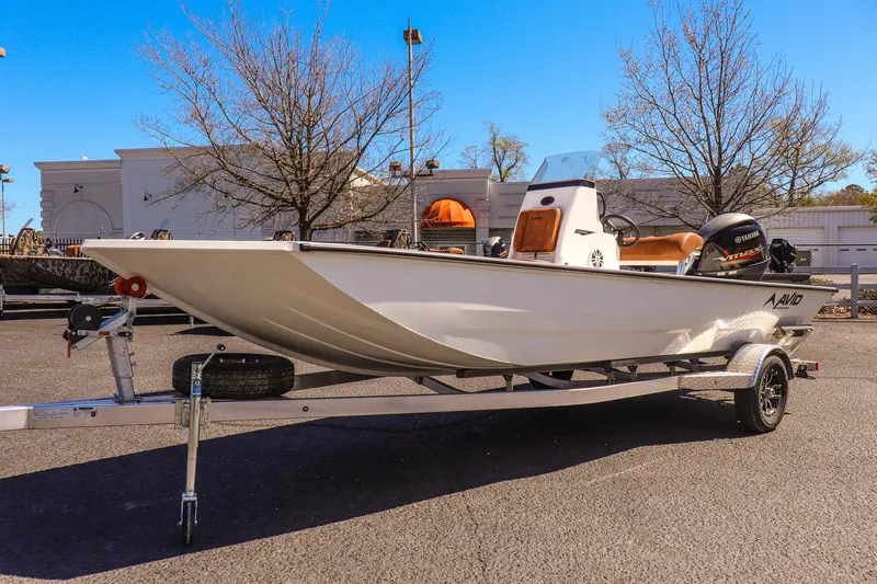 Slide: The Image of 2025 Avid 20 ROGUE CC boat on trailer, parked outdoors. - 7