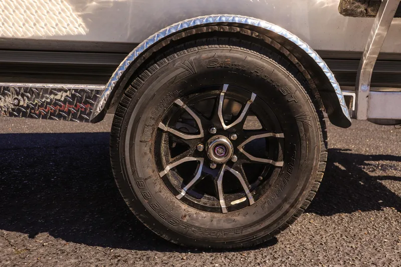 Slide: The Image of Trailer wheel of 2025 Avid 20 ROGUE CC with black alloy rim. - 9