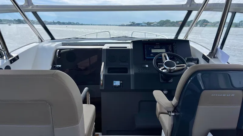 Slide: The Image of Interior view of 2025 Nimbus Weekender 11 #49 boat cockpit with steering wheel and controls. - 10