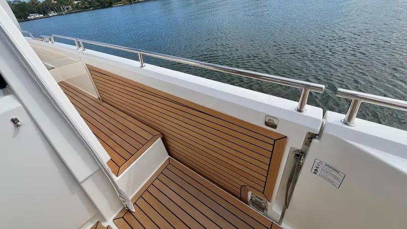 Slide: The Image of Teak deck of 2025 Nimbus Weekender 11 #49 yacht by the water. - 11