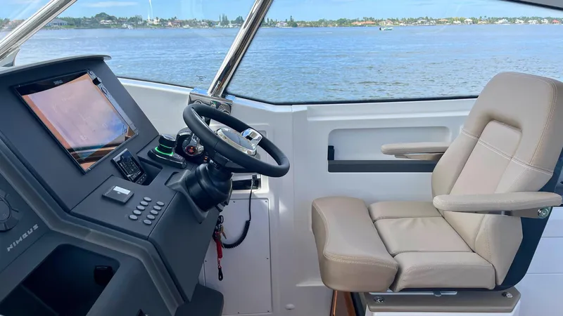 Slide: The Image of Interior of 2025 Nimbus Weekender 11 #49 boat with steering and seating. - 16