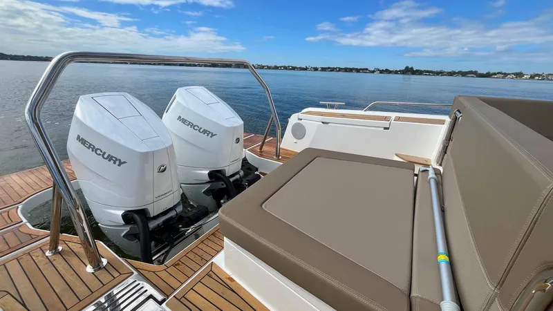 Slide: The Image of Twin Mercury engines on a 2025 Nimbus Weekender 11, docked on a sunny day. - 23