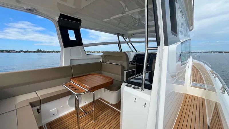 Slide: The Image of Luxurious 2025 Nimbus Weekender 11 #49 yacht interior with seating and wooden deck. - 25