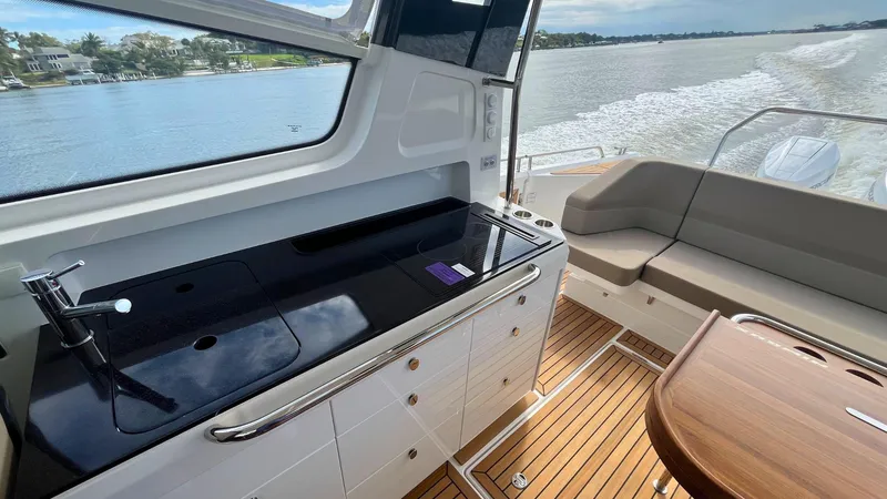 Slide: The Image of Luxurious interior of 2025 Nimbus Weekender 11 yacht with sleek kitchen and seating area. - 26