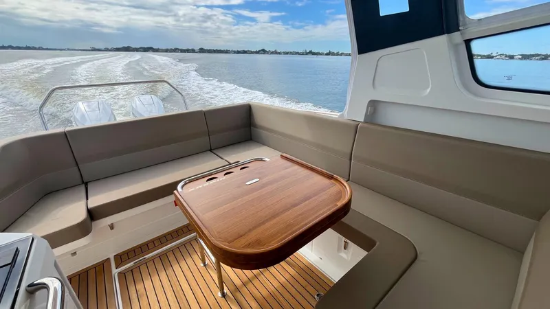 Slide: The Image of Luxurious interior of 2025 Nimbus Weekender 11 #49 boat with wooden table and seating. - 27