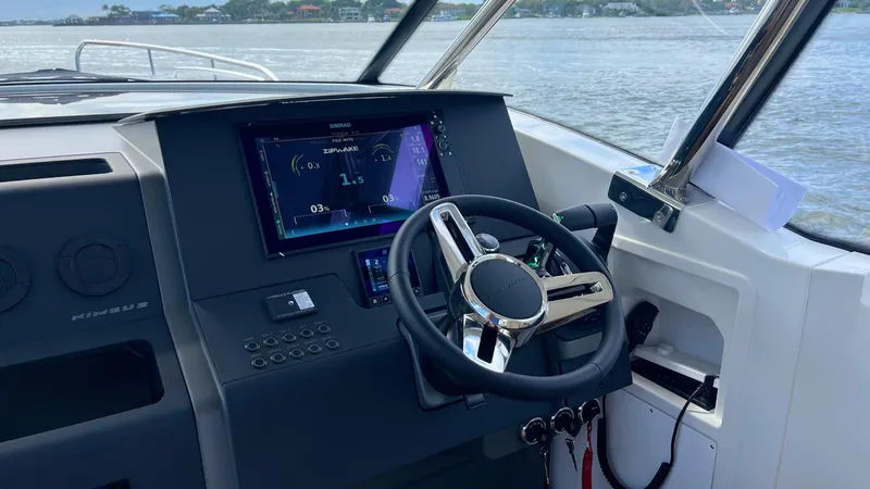 Slide: The Image of Cockpit of 2025 Nimbus Weekender 11 #49 boat with modern steering and digital display. - 3